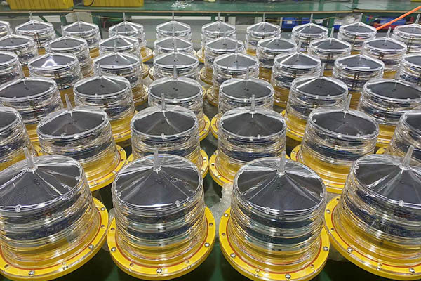 solar powered obstruction light YFFY Lights Rows of round transparent domes on yellow bases in an industrial manufacturing setting