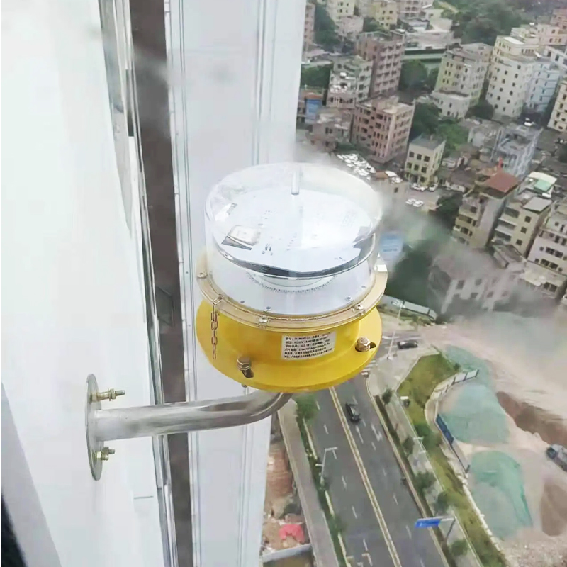 Close up of a dome style sensor mounted on a yellow base attached to a high rise exterior overlooking a city street below