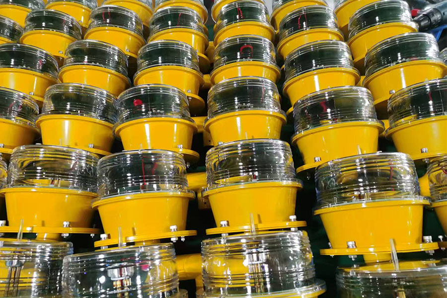 ICAO Type B obstruction light YFFY Lights Rows of bright yellow plastic buckets with clear lids stacked in a warehouse setting ready for shipment or storage