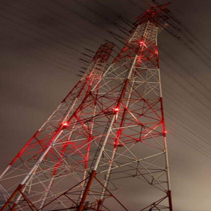 Transmission Tower Obstruction Lights Aviation Obstruction Lights 2 YFFY Lights Transmission Tower Obstruction Lights Aviation Obstruction Lights Tall red and white communications tower angled against a cloudy night sky with red aviation lights visible along the structure